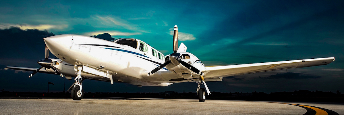 Photo of white and blue private charter airplane for lease to Bahamas Marsh Harbour North Eleuthera Harbour Island Treasure Cay Chub Cay Staniel Cay Governor's Harbour Discount Price Airline Airfare Best Price Guaranteed Private Air Jet Charter