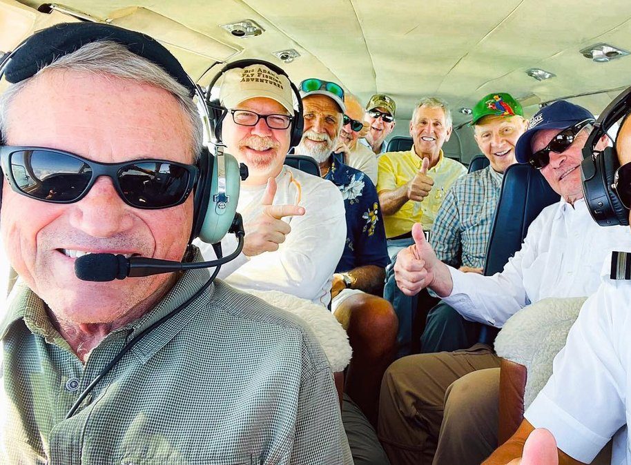 Fishermen flying on private charter flight to Andros Island Bahamas Group of happy fishermen flying onboard a Bahamas Charter Flights private plane on flight to Andros Island Bahamas Congo Town Airport.